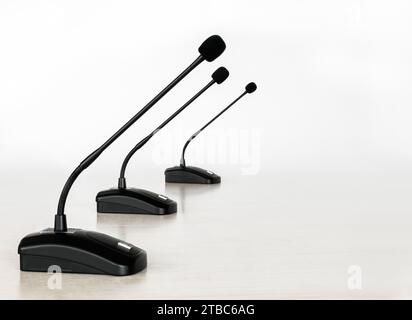 Three cardioid gooseneck microphones for conference and desktop systems in a row on a white background Stock Photo