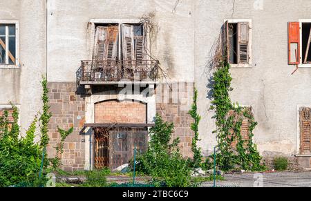 old dilapidated building - dilapidated historic hotel, - building to be demolished Mezzocorona, Trentino Alto Adige, northern Italy Stock Photo