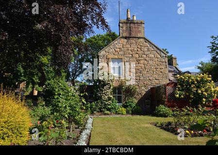 Gable end of a traditional stone house with garden in Sutherland, Scotland Stock Photo