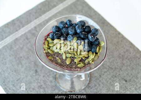 a fresh bowl of acai ice cream topped with various seeds and berries close up Stock Photo