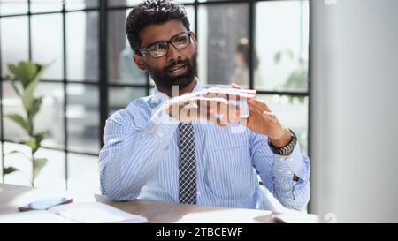Nervous millennial male freelancer see critical mistake incorrect information in paper document Stock Photo