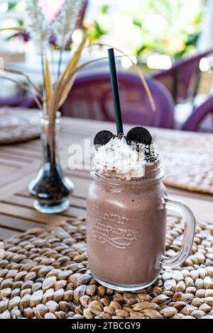 a close up image of a milk chocolate smoothie milkshake in a restaurant. Stock Photo