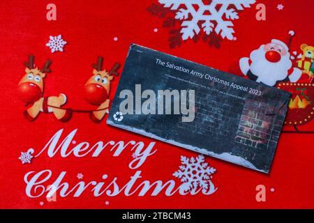 Post mail on Merry Christmas doormat - Christmas appeal from the Salvation Army back of envelope Stock Photo