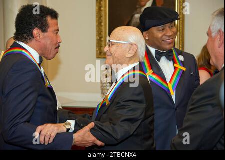 Lionel Richie, left, shares an embrace with Norman Lear, left center, while LL COOL J, center right, converses with United States Secretary of State Rex Tillerson, right, prior to the five recipients of the 40th Annual Kennedy Center Honors posing for a group photo following a dinner hosted by Secretary Tillerson in their honor at the US Department of State in Washington, DC on Saturday, December 2, 2017. The 2017 honorees are: American dancer and choreographer Carmen de Lavallade; Cuban American singer-songwriter and actress Gloria Estefan; American hip hop artist and entertainment icon LL Stock Photo