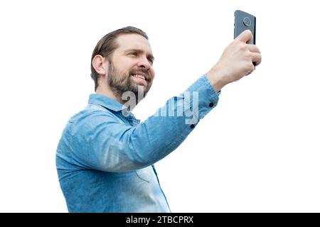Latino Caucasian man in jean shirt taking a selfie. Stock Photo