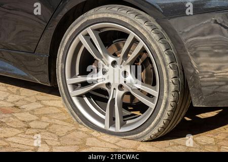 Burst flat car tire wheel. On a car Stock Photo