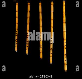 Bamboo flute. Wind instrument of various sizes. isolated on black background Stock Photo