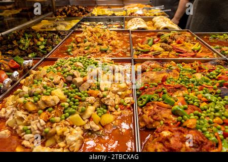 Many varieties of hot and juicy Turkish dishes in a restaurant. The cook serves food. Turkish and middle eastern food cuisine Stock Photo