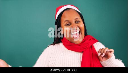 Excited young woman jumps and dances excited for Christmas, studio Stock Photo