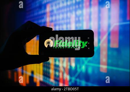 In this photo illustration a Fidelity Investments logo is displayed on a smartphone with stock market percentages in the background. Stock Photo