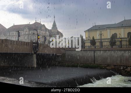 Heavy rain on a summer day in Oradcea, Romania. View of the Black Eagle palace on a rainy day. Stock Photo