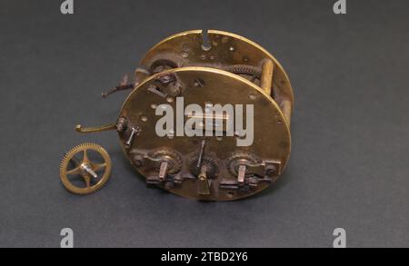 Mechanism from an old grandfather clock. Steampunk bronze attribute. Stock Photo