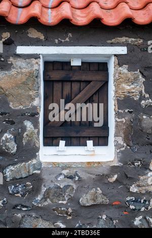 Boarded up window on a cottage in November. Crovie, Aberdeenshire, Scotland Stock Photo
