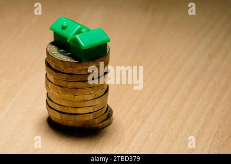 Financial Concept. Monopoly houses and cash, money, loans, mortgages , pension and debt. Small People Stock Photo