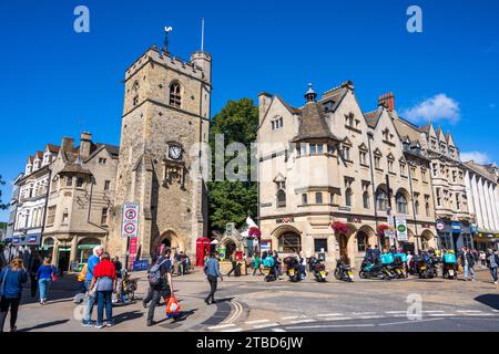 Carfax Tower, once part of a 12th-century church, with buildings on Cornmarket Street in Oxford City Centre, Oxfordshire, England, UK Stock Photo