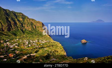 Islets, Scoglio Faraglione, green bay, houses, Filicudi island, Spiaggia di Pollara, Pollara beach, Pollara, Salina, Aeolian Islands, Sicily, Italy Stock Photo