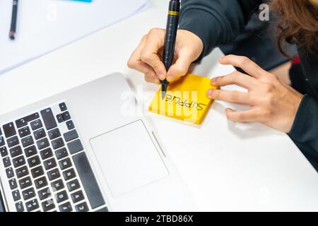 Top view close-up of an engineer writing into a adhesive note during brainstorming meeting Stock Photo