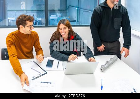 Smiling people working on a meeting of colleagues of a computer numerical control industry Stock Photo