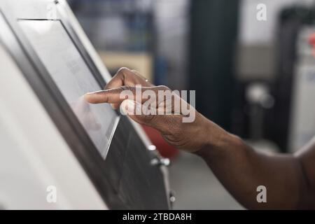 Side view closeup of male hand operating touch screen control panel and using machines at factory, copy space Stock Photo