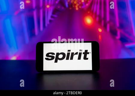 In this photo illustration, a spirit airlines logo is seen displayed on a mobile phone screen. Stock Photo