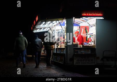 Aston Villa fans grab a bite to eat from a street vendor outside Villa ...