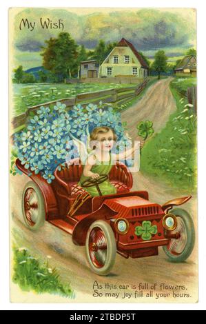 Original, charming, Edwardian birthday greetings card, an angel sits in an early motor car holding lucky clover, forget me not flowers in boot, posted 19 April 1910, London, U.K. Stock Photo