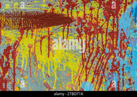 White plastered wall splattered with red paint. Paint splashes on the wall. Painted plaster wall. Abstract background. Painted plaster texture. Stock Photo