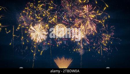 Brightly colorful fireworks for New Years, Christmas, wedding and other events celebration on blue dark cloudy sky. Stock Photo