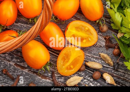 orange plum cherry tomato on wood background Stock Photo