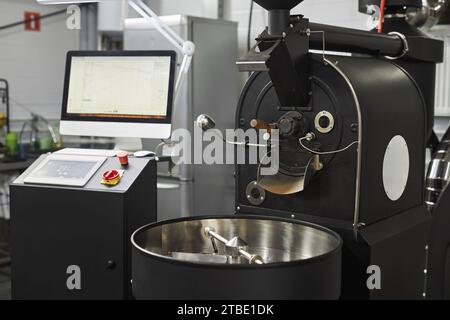 Background of industrial coffee roaster in workshop of food factory, copy space Stock Photo