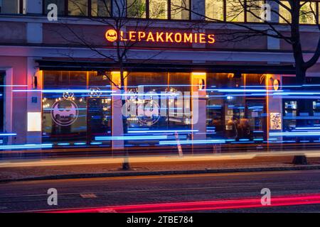 Lepakkomies dive bar and music venue after dark with emergency vehicle light streaks in Harju district of Helsinki, Finland Stock Photo