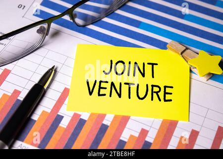 Text JOINT VENTURE text on sticky on keyboard, business concept. Stock Photo