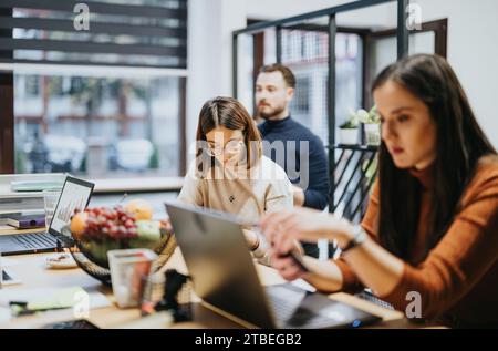 Late Afternoon Business Meeting with Cross Generational Colleagues Discussing Profit Growth and Analyzing Sales Statistics Stock Photo