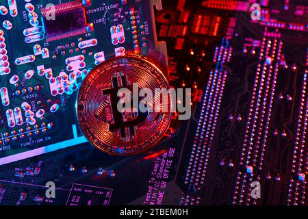 Bitcoin cryptocurrency token coin against circuit board background Stock Photo
