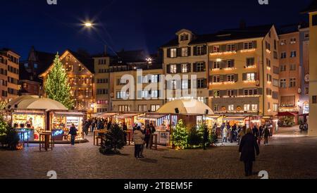 Zurich, Switzerland - November 23, 2023: Christmas market at Munsterhof square in Zurich in blue hour Stock Photo