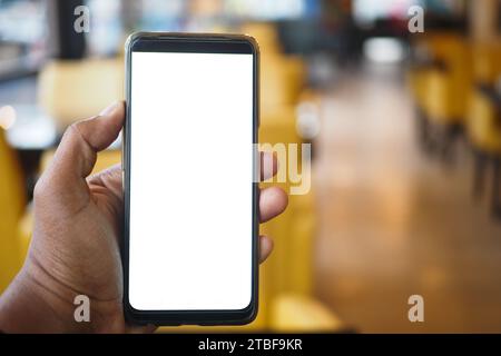 young man hand using smart phone with white screen at cafe  Stock Photo