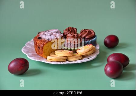 Closeup of Easter cookies and painted eggs on green background Stock Photo