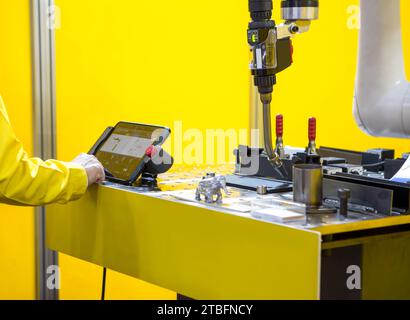 Industrial mechanical technician control robot arc welding. Stock Photo