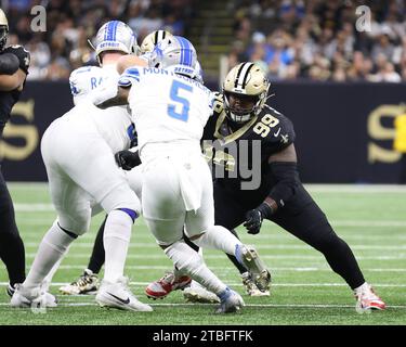 New Orleans Saints defensive tackle Khalen Saunders (99) tries to tackle Detroit Lions running back David Montgomery (5) during a National Football League game at Caesars Superdome in New Orleans, Louisiana on Sunday, December 3, 2023.  (Photo by Peter G. Forest/Sipa USA) Stock Photo