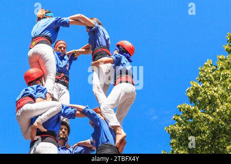 GIRONA, SPAIN - MAY 14, 2017: This is the construction of a tower of people, called castel, during the city tht Flower Festival. Stock Photo
