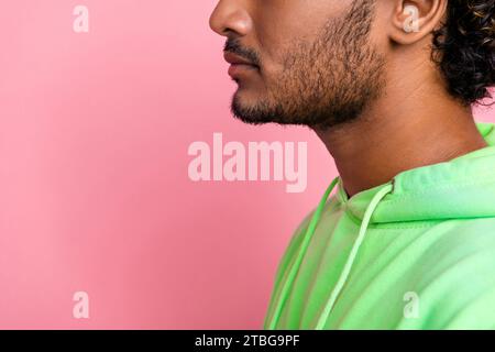 Side profile cropped photo unshaven unrecognizable indian serious man looking copy space skincare promo isolated on pink color background Stock Photo