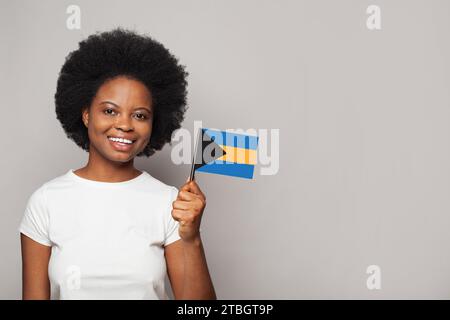 Bahamian woman holding flag of Bahamas Education, business, citizenship and patriotism concept Stock Photo