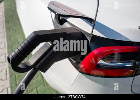 Tesla model 3 electric car rapid charging on a public power station Stock Photo