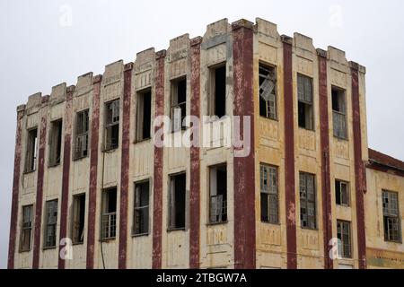 Dilapidated old building with broken windows Stock Photo