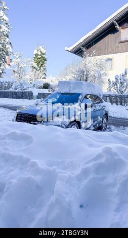 A fully snow covered roof of a car after heavy snowfalls Stock Photo
