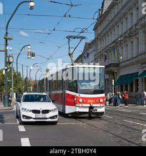 Road traffic with car and streetcar on Smetanovo nabrezi Street in the center of Prague near the Vltava River Stock Photo