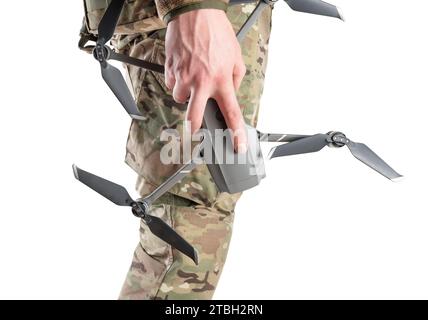 Drone in hand of military soldier in camouflage uniform. Side view on a white background. Concept of drones in modern war. Stock Photo