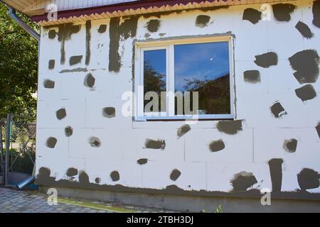 Polystyrene Insulation Of Facade Styrofoam house with a window Stock Photo