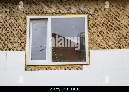 insulate the wooden house of Styrofoam from the windows Stock Photo