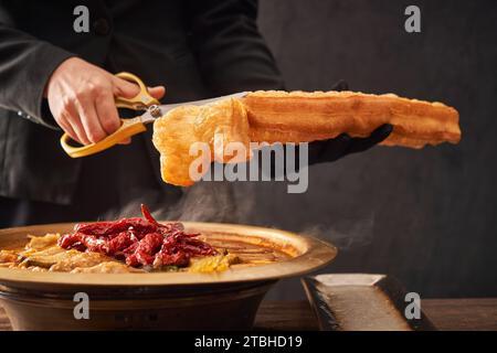 Stewed Carp fish head in Brown Sauce served with Deep Fried Dough Stick Stock Photo